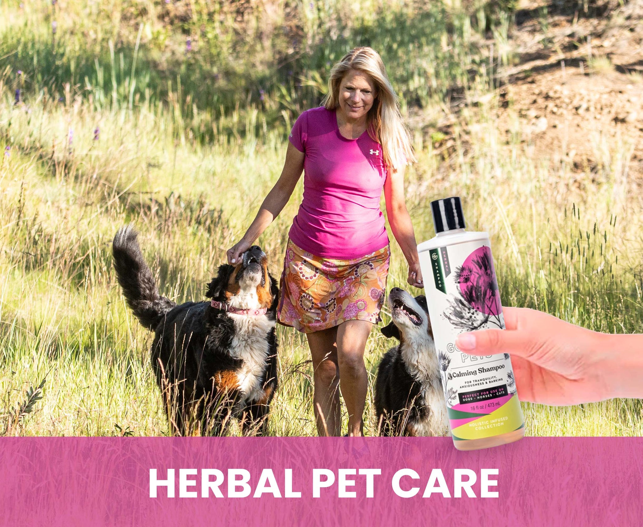 Woman walking dogs in a field with a bottle of herbal pet care product.