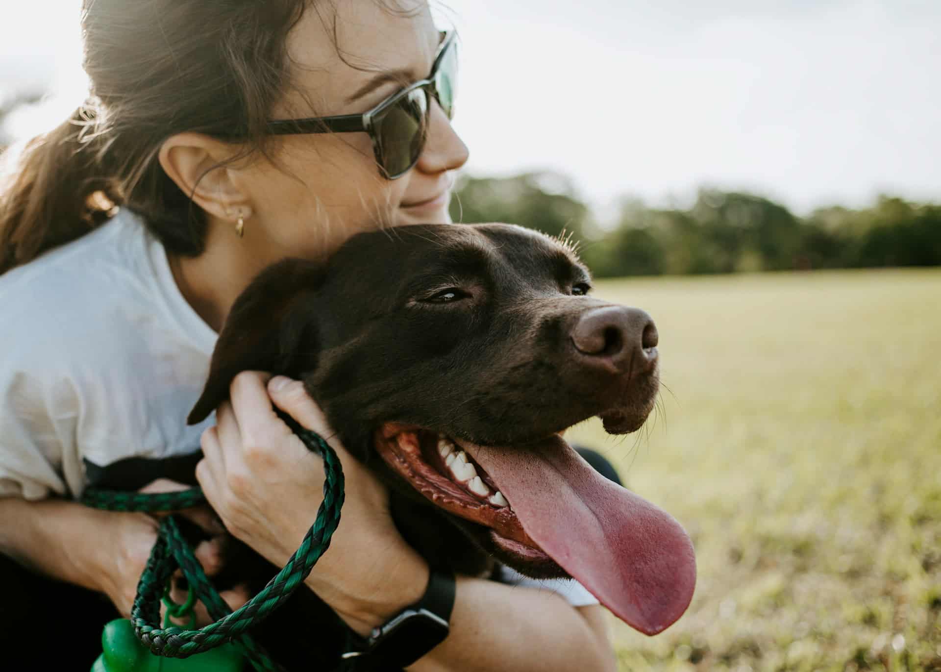 Fur parent embraces dog whining, expressing canine communication and emotional connection