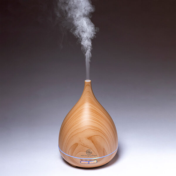 Wooden oil diffuser for pets blue hues background.